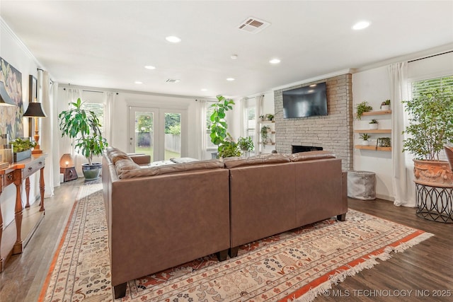 1628 E 45th Pl, Tulsa, OK 74105 - living room with wood finished floors, plenty of natural light, recessed lighting, a brick fireplace, and ornamental molding