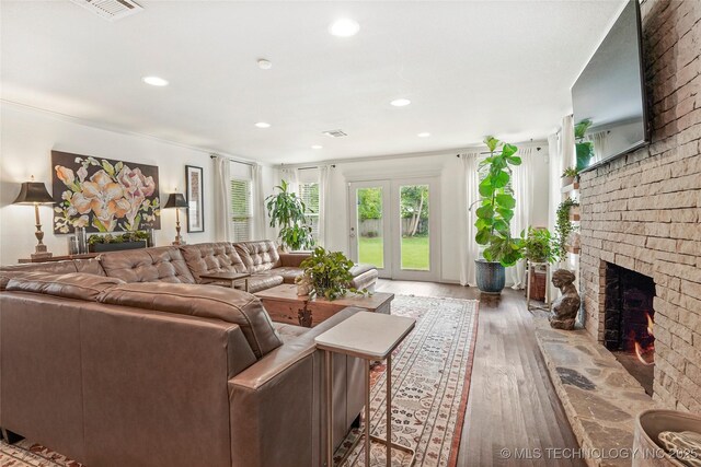 1628 E 45th Pl, Tulsa, OK 74105 - living area featuring a brick fireplace, wood finished floors, and recessed lighting