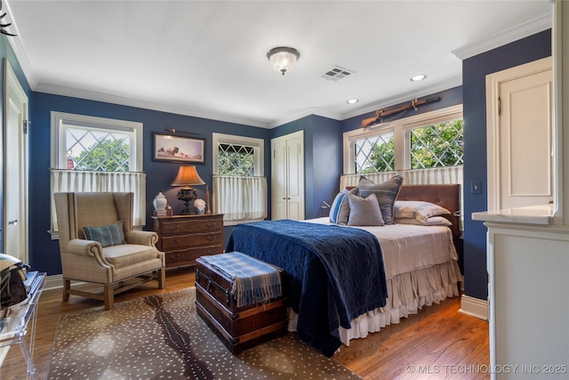 1249 E 26th St, Tulsa, OK 74114 - bedroom with multiple windows, ornamental molding, wood finished floors, and a closet