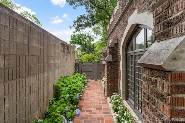 1249 E 26th St, Tulsa, OK 74114 - view of home's exterior with a gate and brick siding