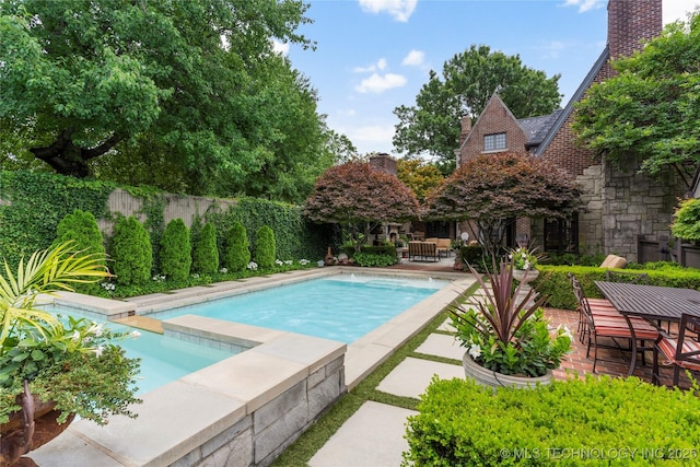 1249 E 26th St, Tulsa, OK 74114 - view of pool with a patio, outdoor dining area, and a fenced backyard