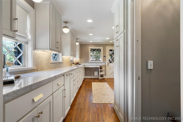 1249 E 26th St, Tulsa, OK 74114 - kitchen with dark wood-style flooring, tasteful backsplash, white cabinetry, light stone countertops, and recessed lighting