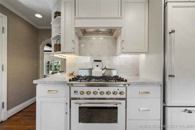 1249 E 26th St, Tulsa, OK 74114 - kitchen featuring high end stove, ornamental molding, white cabinetry, dark wood-style floors, and light stone counters