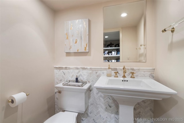 1249 E 26th St, Tulsa, OK 74114 - half bath featuring tile walls, wainscoting, and recessed lighting