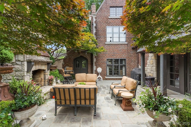 1249 E 26th St, Tulsa, OK 74114 - view of patio with area for grilling and an outdoor living space with a fireplace