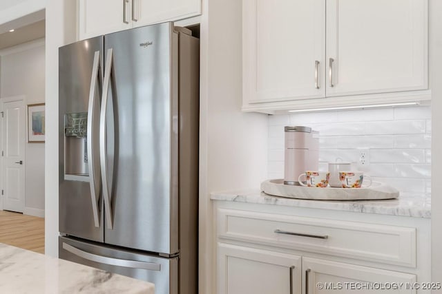 6501 S Fir Ave, Broken Arrow, OK 74134 - kitchen with stainless steel refrigerator with ice dispenser, decorative backsplash, white cabinets, light stone counters, and wood finished floors
