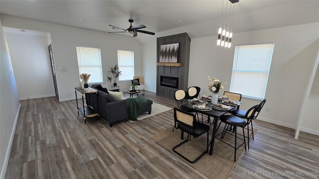 1135 E Zion St, Tulsa, OK 74106 - dining room featuring a fireplace, ceiling fan, and wood finished floors