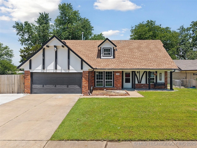 10905 E 24th St, Tulsa, OK 74129 - tudor home with a garage, driveway, roof with shingles, covered porch, and brick siding