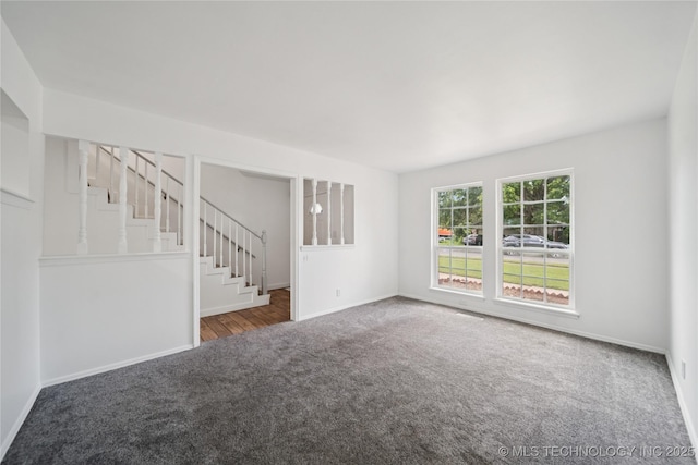 10905 E 24th St, Tulsa, OK 74129 - unfurnished living room featuring carpet flooring and stairway