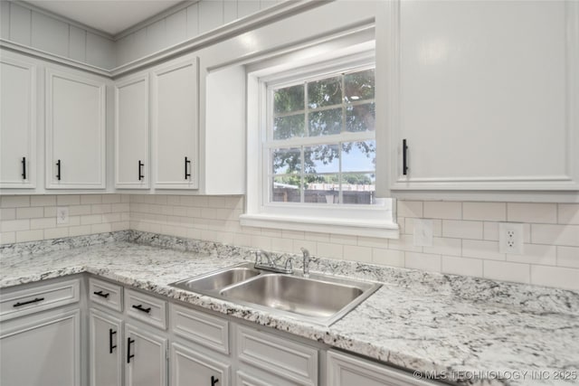 10905 E 24th St, Tulsa, OK 74129 - kitchen featuring white cabinetry and decorative backsplash