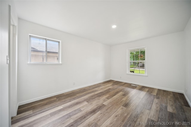 10905 E 24th St, Tulsa, OK 74129 - spare room featuring hardwood / wood-style flooring and recessed lighting