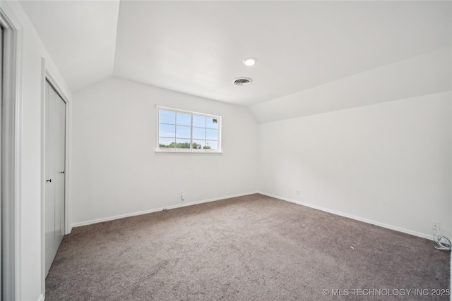 10905 E 24th St, Tulsa, OK 74129 - unfurnished bedroom with vaulted ceiling and carpet flooring