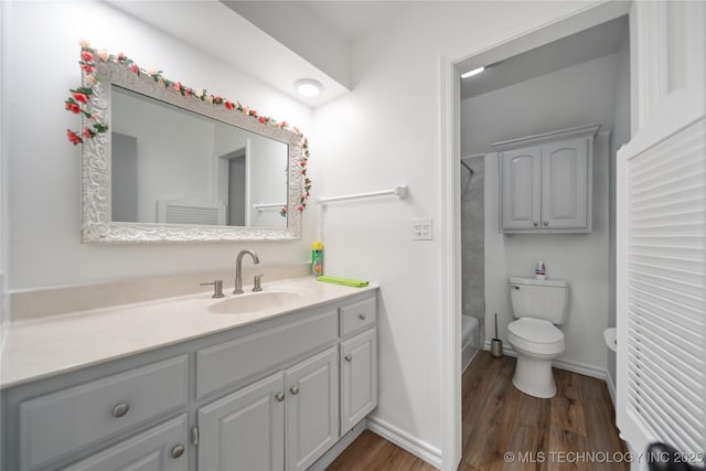 10905 E 24th St, Tulsa, OK 74129 - bathroom with wood finished floors, vanity, and bathing tub / shower combination