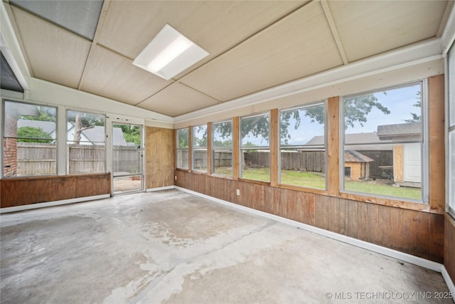 10905 E 24th St, Tulsa, OK 74129 - unfurnished sunroom with concrete flooring, vaulted ceiling, and wooden walls