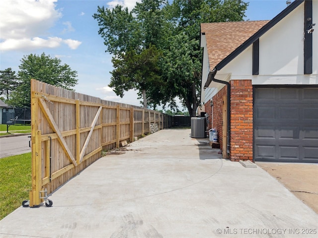 10905 E 24th St, Tulsa, OK 74129 - view of patio / terrace with concrete driveway and a garage
