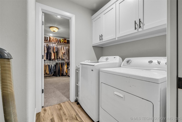 25133 Shade Tree Pl, Claremore, OK 74019 - laundry room with separate washer and dryer, cabinet space, and light wood-type flooring