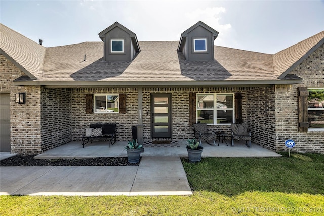 25133 Shade Tree Pl, Claremore, OK 74019 - back of property featuring brick siding, a patio, and a shingled roof