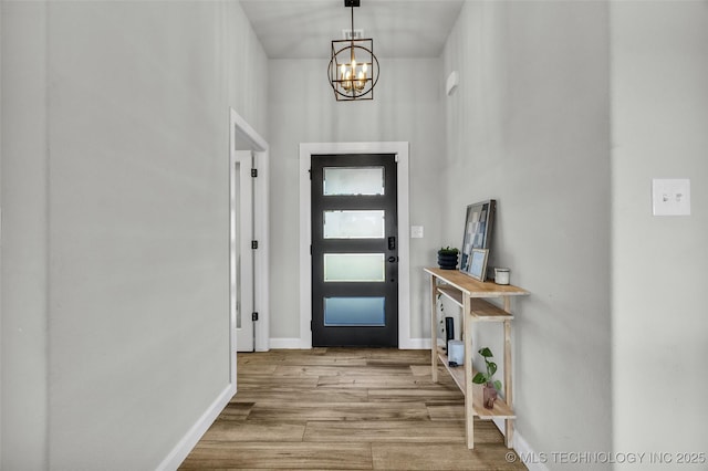 25133 Shade Tree Pl, Claremore, OK 74019 - entrance foyer with a chandelier and wood finished floors