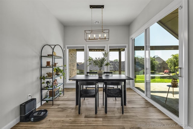 25133 Shade Tree Pl, Claremore, OK 74019 - dining area with a chandelier and wood finished floors
