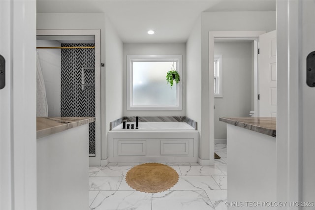 25133 Shade Tree Pl, Claremore, OK 74019 - bathroom featuring marble look tiles, a garden tub, recessed lighting, and a shower