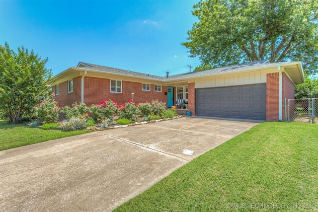 5122 E 27th Pl, Tulsa, OK 74114 - ranch-style home with brick siding, a garage, and driveway