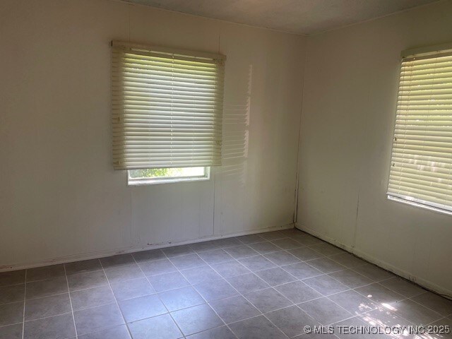 720 B NE, Ardmore, OK 73401 - unfurnished room featuring tile patterned flooring and baseboards
