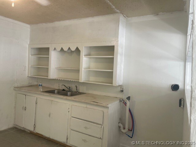 720 B NE, Ardmore, OK 73401 - kitchen featuring open shelves, light countertops, and white cabinets
