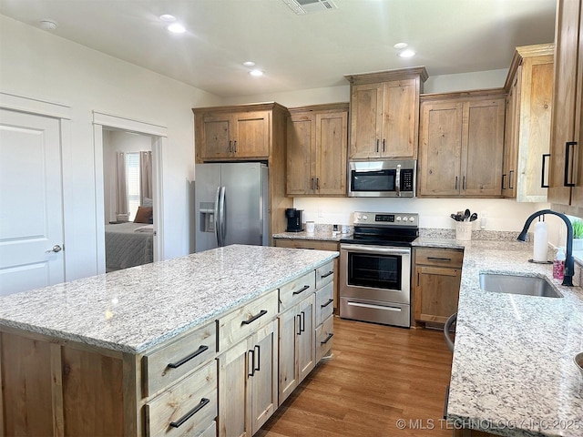 775 E Finley Ridge Dr, Tahlequah, OK 74464 - kitchen featuring stainless steel appliances, dark wood-style flooring, a center island, light stone countertops, and recessed lighting