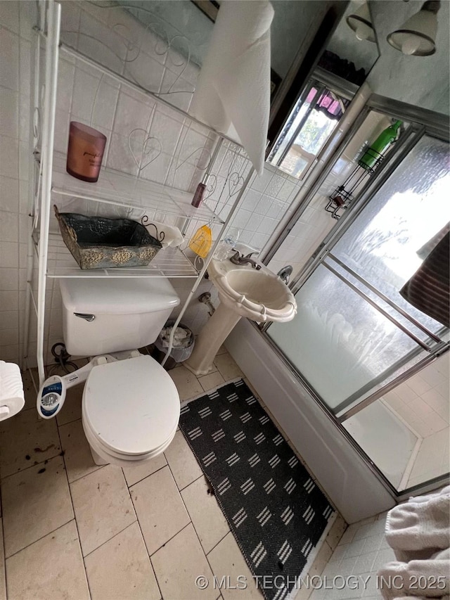 13226 N 91st Ave E, Collinsville, OK 74021 - full bathroom with tile walls, tile patterned flooring, and a shower