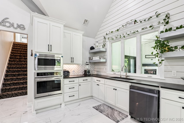 7604 S 6th St, Broken Arrow, OK 74011 - kitchen with stainless steel appliances, open shelves, light marble finish flooring, dark countertops, and high vaulted ceiling