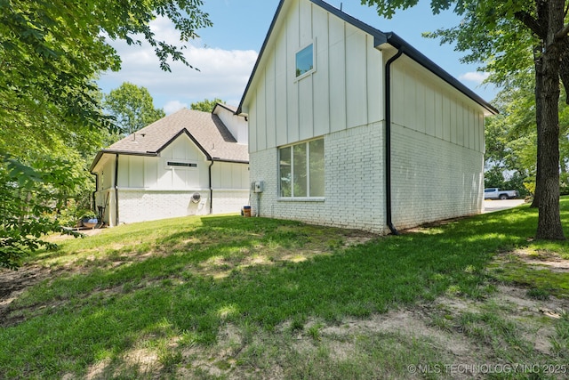 7604 S 6th St, Broken Arrow, OK 74011 - view of side of property with board and batten siding, brick siding, and a lawn
