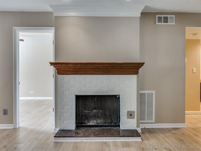 4654 E 68th St S Unit 199, Tulsa, OK 74136 - detailed view of crown molding, wood finished floors, and a brick fireplace