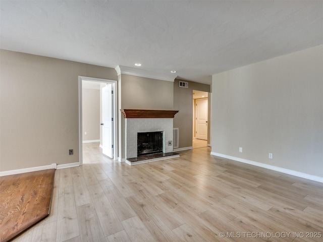 4654 E 68th St S Unit 199, Tulsa, OK 74136 - unfurnished living room with a brick fireplace, light wood finished floors, and recessed lighting