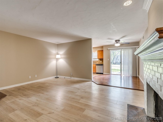 4654 E 68th St S Unit 199, Tulsa, OK 74136 - unfurnished living room with a brick fireplace, a ceiling fan, and light wood-type flooring