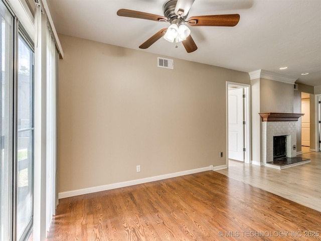 4654 E 68th St S Unit 199, Tulsa, OK 74136 - unfurnished living room with a ceiling fan, wood finished floors, and a brick fireplace
