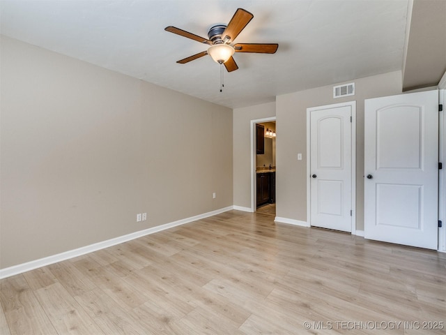 4654 E 68th St S Unit 199, Tulsa, OK 74136 - unfurnished bedroom with light wood-style floors, ensuite bath, and a ceiling fan