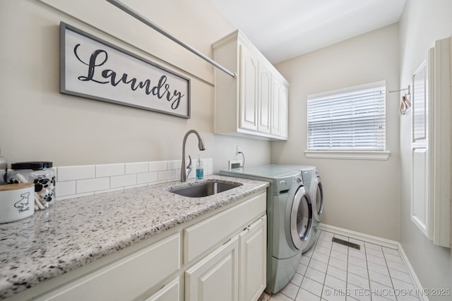 13614 W 42nd Pl, Sand Springs, OK 74063 - laundry room with washer and clothes dryer, cabinet space, and light tile patterned flooring