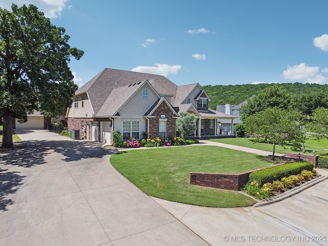 13614 W 42nd Pl, Sand Springs, OK 74063 - craftsman house with driveway, a front lawn, brick siding, stucco siding, and a shingled roof