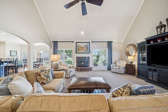 13614 W 42nd Pl, Sand Springs, OK 74063 - carpeted living room featuring high vaulted ceiling, arched walkways, healthy amount of natural light, a ceiling fan, and crown molding