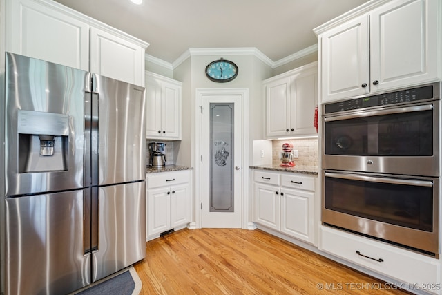 13614 W 42nd Pl, Sand Springs, OK 74063 - kitchen featuring stainless steel appliances, crown molding, white cabinetry, light stone countertops, and decorative backsplash