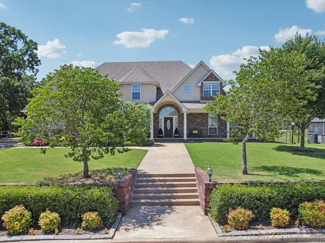 13614 W 42nd Pl, Sand Springs, OK 74063 - view of front of house with stucco siding and a front lawn