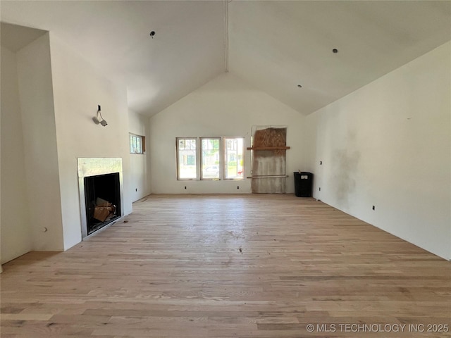 4949 S Boston Pl, Tulsa, OK 74105 - unfurnished living room featuring high vaulted ceiling, a fireplace, and light wood-style floors