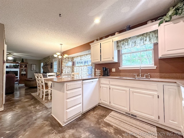 7515 S 108th E Ave, Tulsa, OK 74133 - kitchen featuring dishwasher, a textured ceiling, a chandelier, a peninsula, and concrete floors