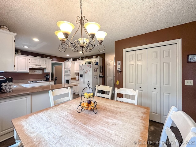 7515 S 108th E Ave, Tulsa, OK 74133 - dining room featuring a textured ceiling, a chandelier, and recessed lighting