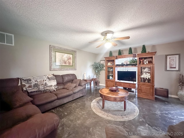 7515 S 108th E Ave, Tulsa, OK 74133 - living area featuring a ceiling fan, finished concrete floors, and a textured ceiling