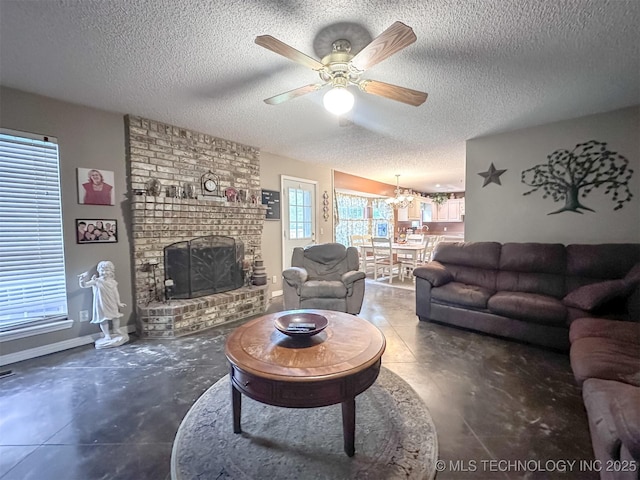 7515 S 108th E Ave, Tulsa, OK 74133 - living room featuring a textured ceiling, a fireplace, ceiling fan, concrete floors, and a chandelier
