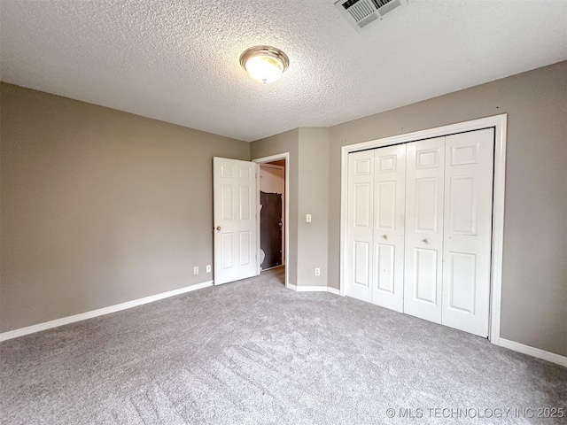 7515 S 108th E Ave, Tulsa, OK 74133 - unfurnished bedroom featuring carpet floors, a closet, and a textured ceiling