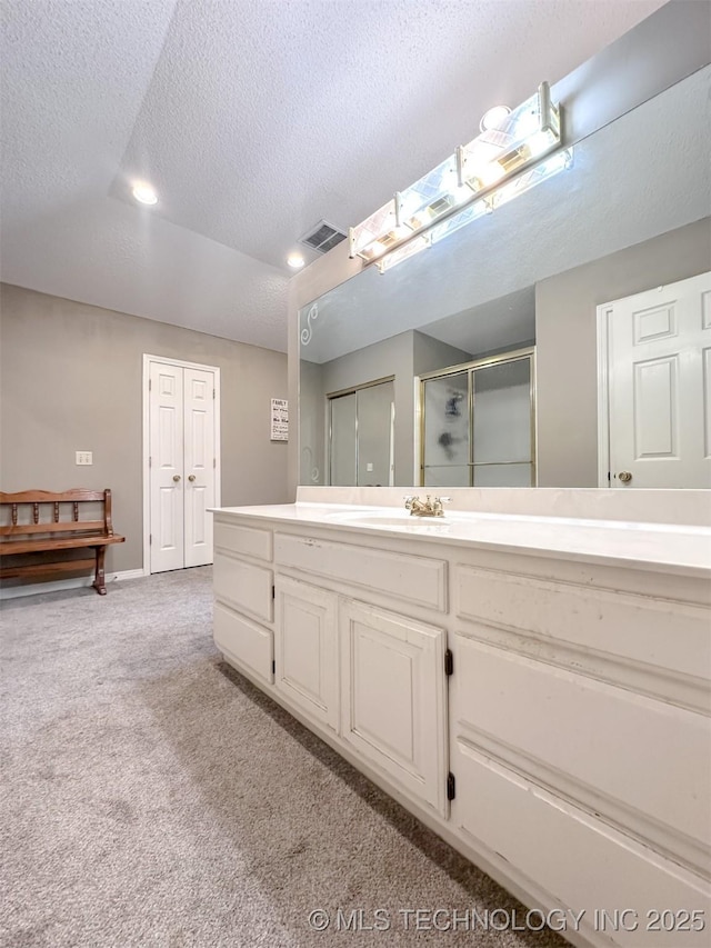 7515 S 108th E Ave, Tulsa, OK 74133 - bathroom featuring a textured ceiling, a shower stall, vanity, and carpet