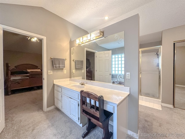 7515 S 108th E Ave, Tulsa, OK 74133 - ensuite bathroom featuring vaulted ceiling, a stall shower, vanity, a textured ceiling, and carpet floors