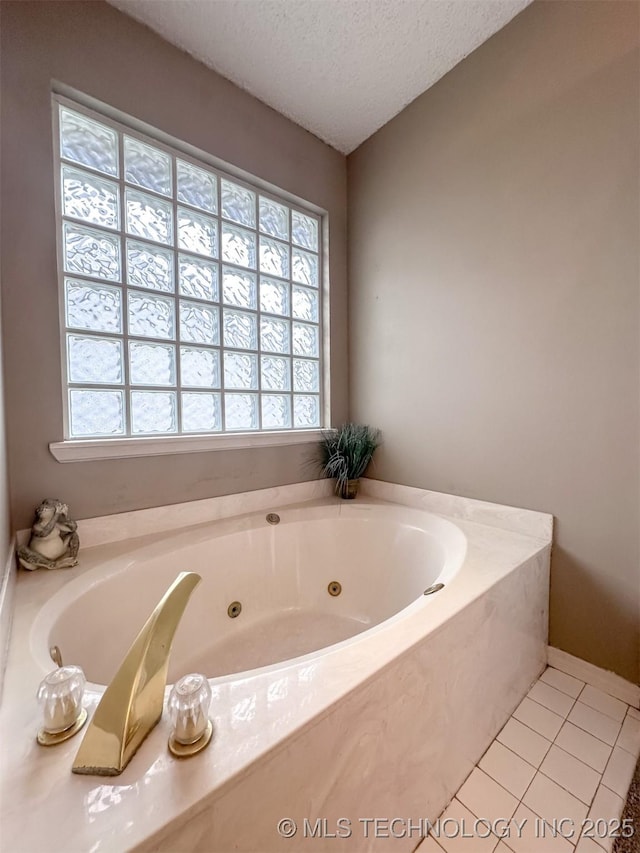 7515 S 108th E Ave, Tulsa, OK 74133 - bathroom featuring a textured ceiling, tile patterned floors, and a tub with jets